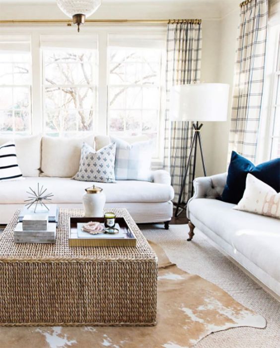 a wicker coffee table and a faux animal skin rug for a cozy feel