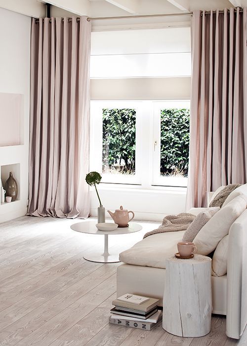 a modern neutral living space with dusty pink curtains to add a pastel touch
