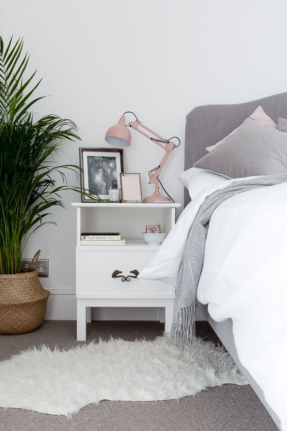 a blush lamp adds a cute colorful touch to the grey and white bedroom