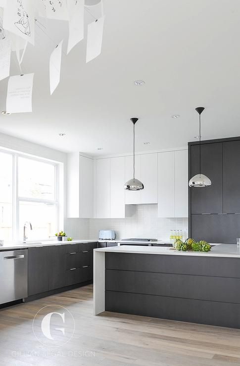 half cabinets done in dark grey and half done in white is a chic combo that will never go out of style