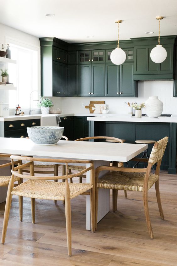 very dark green cabinets are refreshed with a white backsplash and countertops