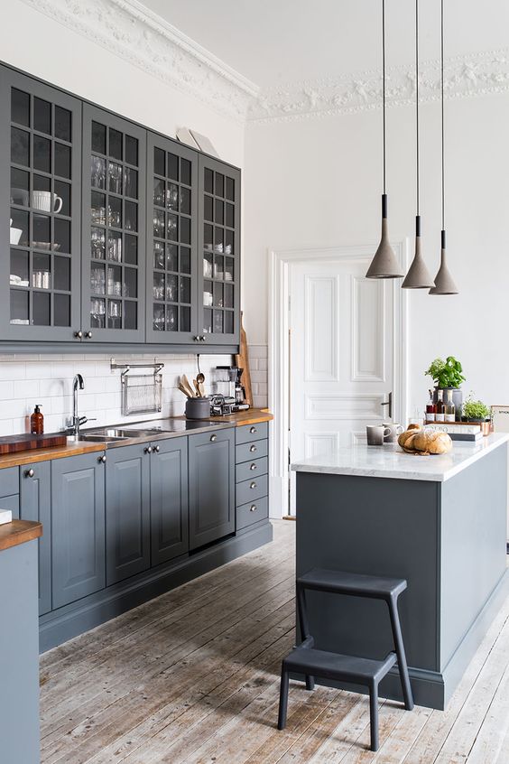 vintage graphite grey kitchen with whitewashed wooden floors, wooden countertops and white walls to make it look fresher