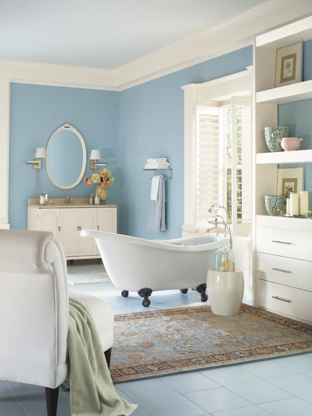 light blue is the main color in the bathroom, cream and white are additional ones, orange and greens are added for a colorful touch
