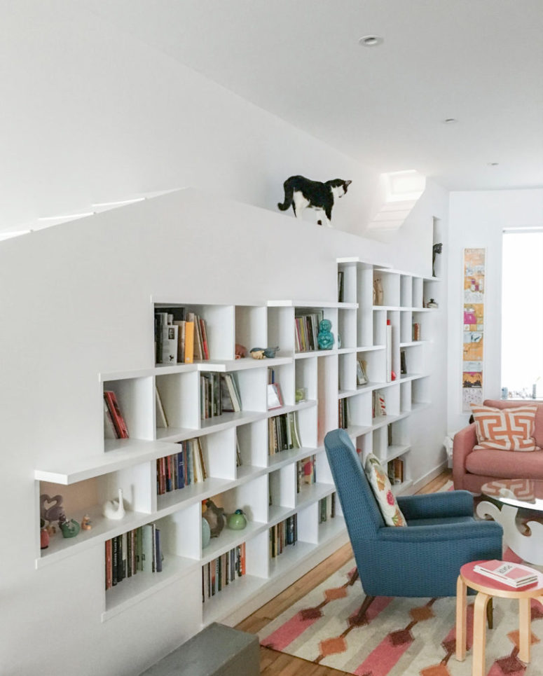 The main piece is a large bookcase, with artworks and books, plus some cat paths
