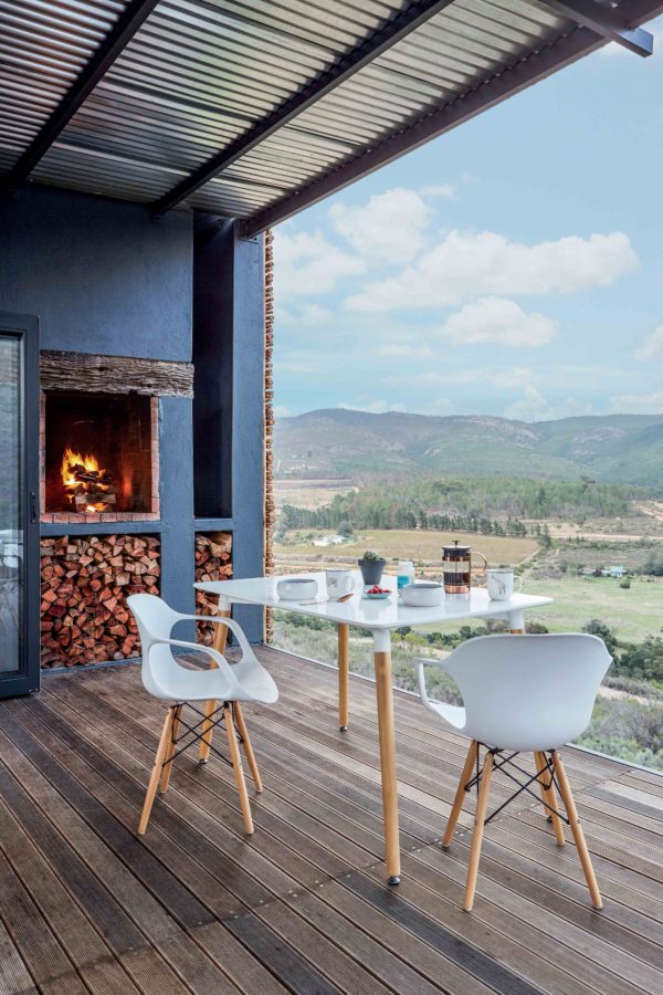 The terrace shows off a hearth and firewood storage, and the dining space is located to get maximum of the views