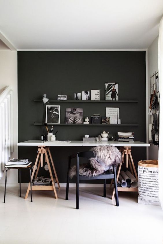 a Scandi space with a black statement wall and ledges, a trestle desk is a comfy solution