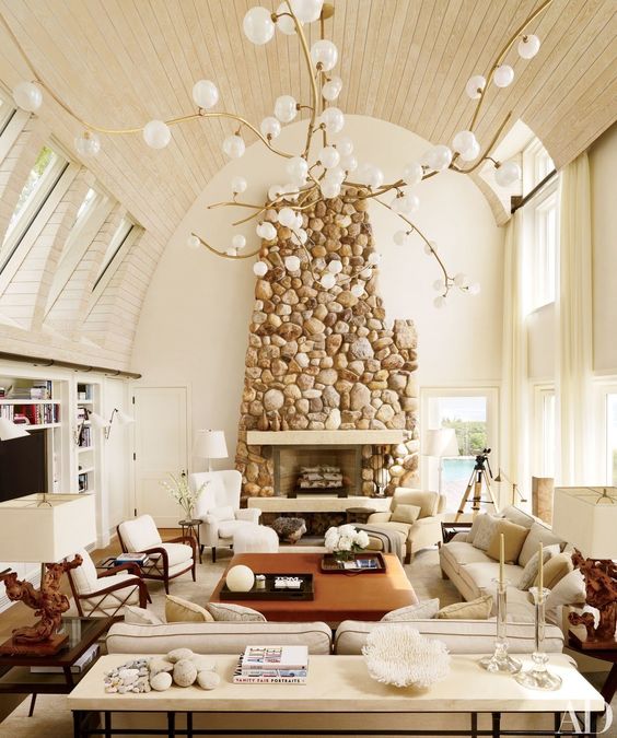 a stunning stone clad fireplace adds texture and makes this neutral space warmer