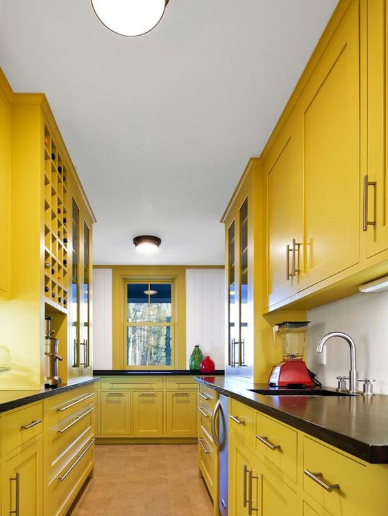 a vintage farmhouse yellow kitchen with black countertops is a bold solution