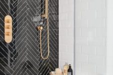 02 black herringbone tiles with white grout for accentuating the shower space and brass touches for a chic look