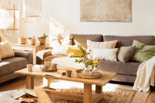 03 The living room features comfy furniture, wooden items and earthy tones in decor