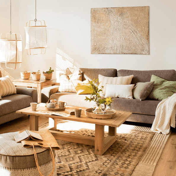 The living room features comfy furniture, wooden items and earthy tones in decor