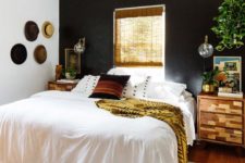 03 a boho and rustic space with a black headboard wall is balanced with warm-colored wood and a window in this wall