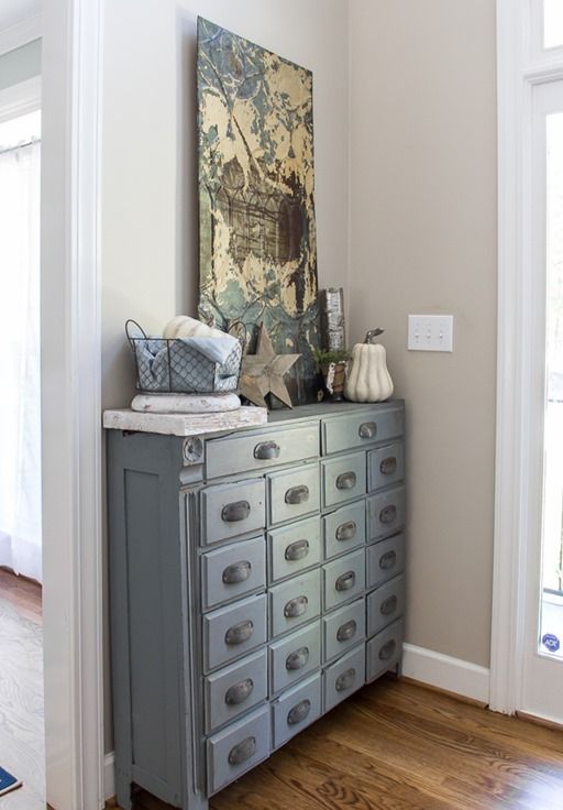 an apothecary cabinet painted slate looks chic and adds a vintage touch to your entryway