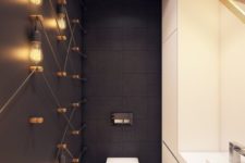 03 matte black tiles and a black matte wall with bulbs all over create a chic and bold modern look