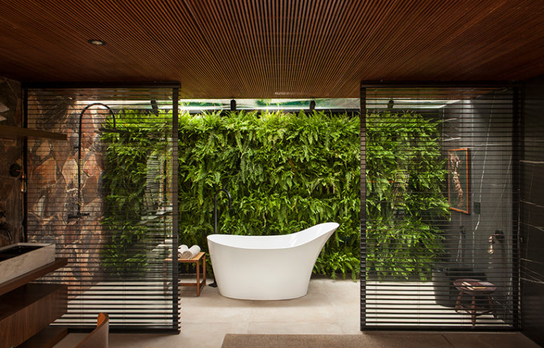 The bathroom also features a gorgeous living wall and wooden screens to divide the sink zone from the bathing one