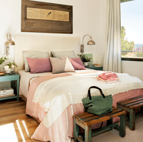 The master bedroom is furnished with shabby chic and vintage items, and the color palette is a pastel one, the views are also present