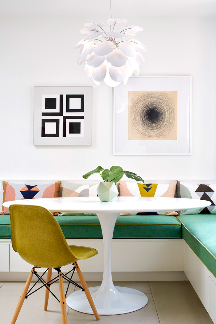 The seating bench is emerald, it adds a bold touch to the space and so does the yellow chair