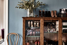 04 There’s a vintage glass sideboard, which is used for storing shoes that the owner loves very much