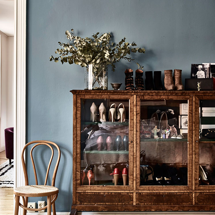 There's a vintage glass sideboard, which is used for storing shoes that the owner loves very much