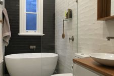 04 a black tile wall creates a bold contrast and makes the bathtub space stand out