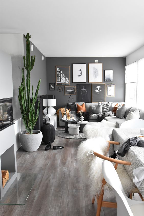 a modern space in neutrals with just one black wall, some desert touches and amber accessories