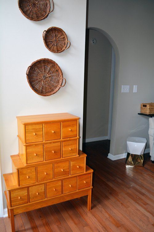 an antique apothecary cabinet in bold orange for accentuating an entryway