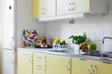04 lemon yellow cabinets and a white tile backsplash look chic, colorful and warming up