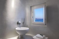 05 The master bathroom features a whumsy free-standing sink on small legs and a small window with a view