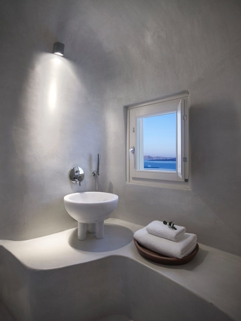 The master bathroom features a whumsy free-standing sink on small legs and a small window with a view