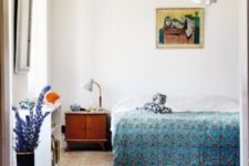 05 The master bedroom is done with mid-century modern furniture, colorful printed textiles, artworks and accessories