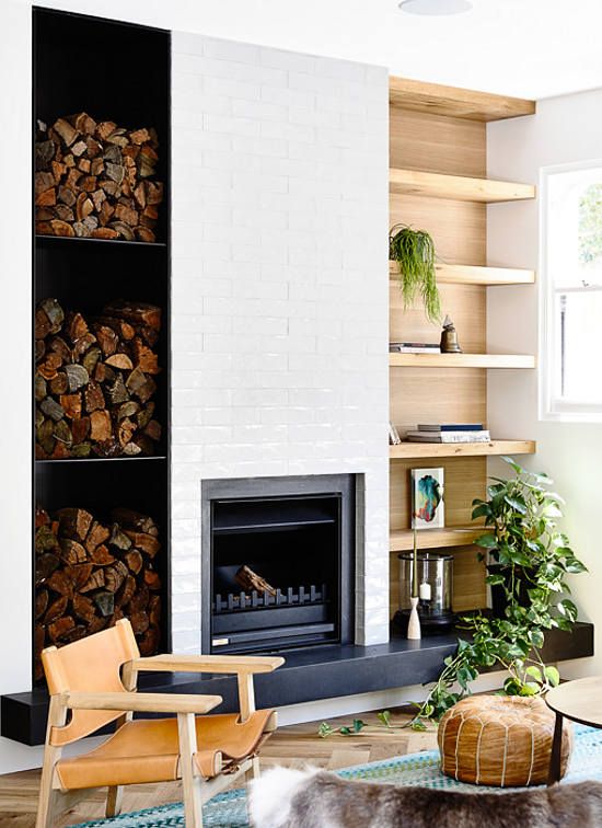 An eclectic space with a built in fireplace and lots of firewood storage for more coziness