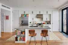06 The kitchen is a neutral one, with metallic surfaces and lots of books, it’s filled with natural light