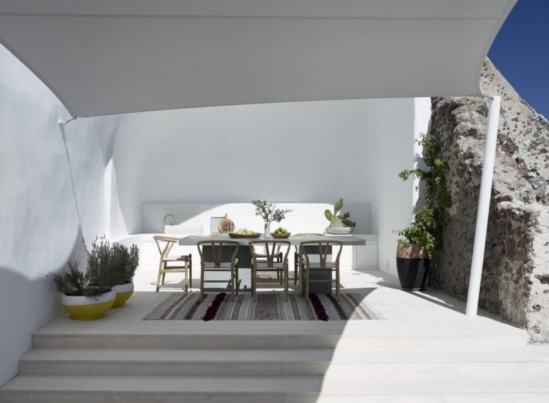 The dining zone is done with a built-in bench, wooden chairs and a concrete dining table