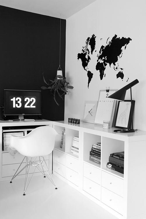a Scandinavian home office with a black statement wall and a white one with a world map decal looks bold