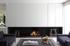 07 a minimalist living room with a built-in fireplace under the cabinets