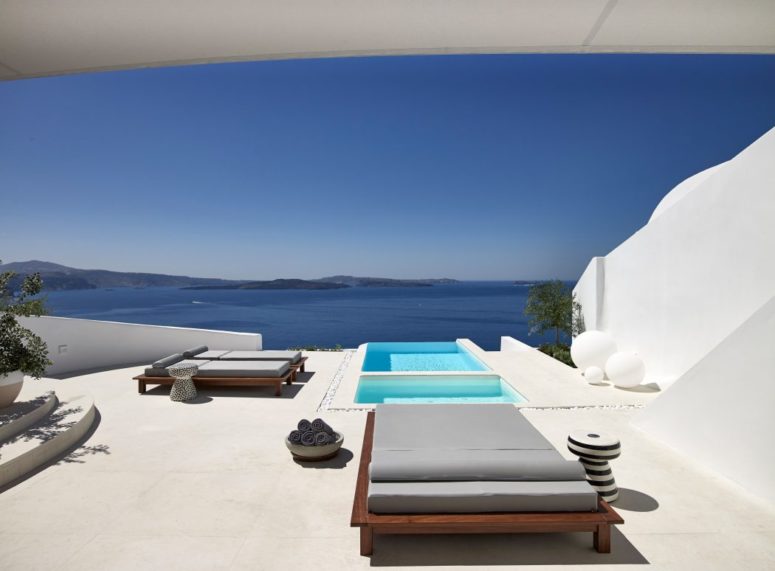 Modern comfy loungers and some cute side tables are placed around pools
