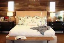 08 a gorgeous wooden wall, an animal skin rug and an upholstered bed add textures to the space