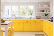 08 a modern farmhouse kitchen in bold yellow, with white marble counters and yellow stools looks airy and sunny