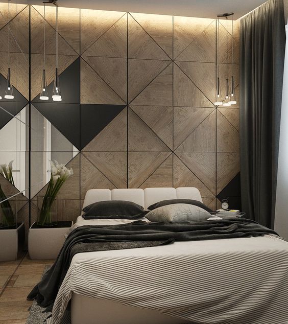 a moody space with a wood geometric headboard wall, glass lamps hanging in clusters