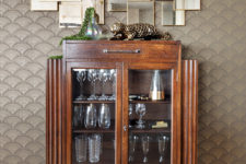 09 A cool wooden and glass bar cabinet with a geo mirror over it added to the interior
