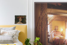 09 The master bedroom raises the mood with cool artworks and a sunny yellow upholstered bed