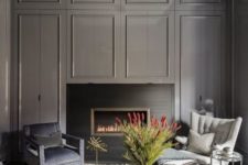 09 a chic moody space with graphite grey walls and a built-in fireplace, a crystal chandelier is a gorgeous statement piece
