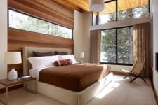 09 a gorgeous space with a wood clad wall with an additional window for more light and a large window to bring the views in