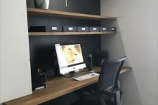 09 a home office with a niche, the depth of which is highlighted with a black wall and a wooden desktop