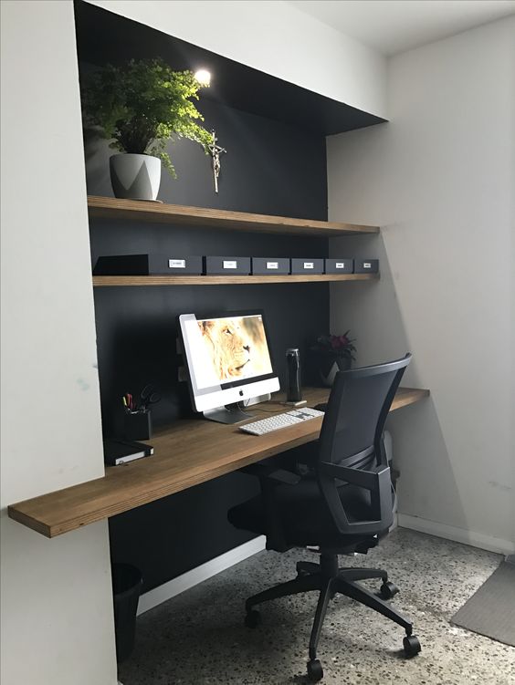 a home office with a niche, the depth of which is highlighted with a black wall and a wooden desktop