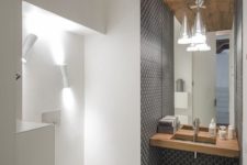 09 the sink zone is accentuated with grey mosaic tiles, and the toilet zone is lit up