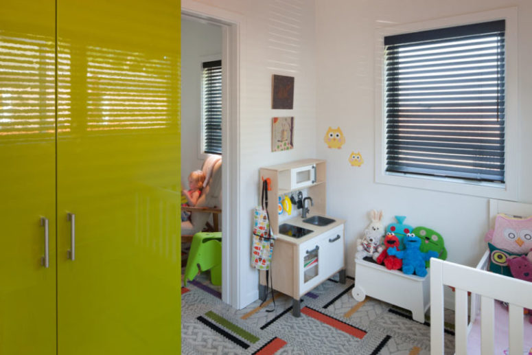 The kids' playroom features a lot of bold colors and many toys