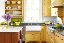 10 a farmhouse kitchen done in sunny yellow and natural warm-colored wood, with dark countertops and open shelving