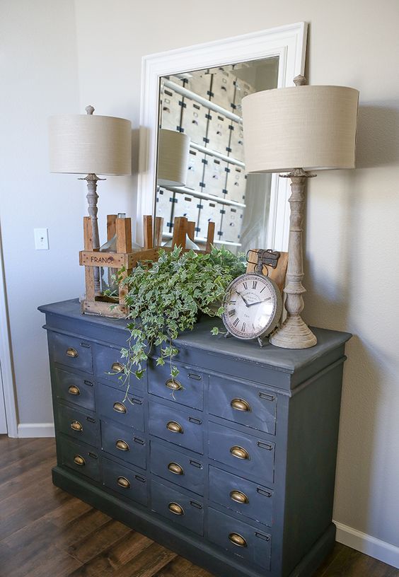 a vintage cabinet painted in graphite grey as a chic and unusual entryway console