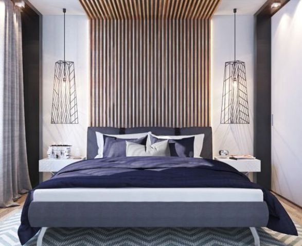 an eye-catchy vertical slat wall coming up the ceiling, geometric lamps and a colorful uphlostered bed